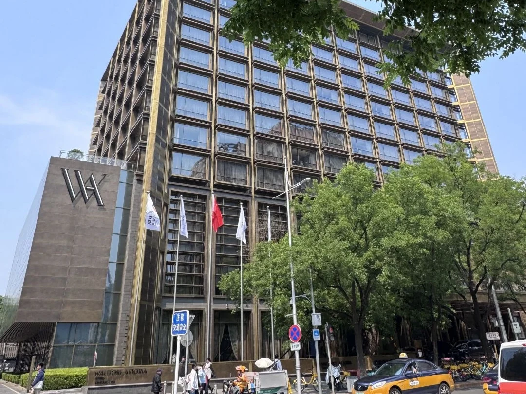 Waldorf Astoria hotel exterior in Beijing Modern high rise facade of the Waldorf Astoria Beijing with street view and trees. - How Much Money Do You Need Per Day in Beijing? 2026 - The China Journey Waldorf Astoria hotel exterior in Beijing Modern high rise facade of the Waldorf Astoria Beijing with street view and trees. - How Much Money Do You Need Per Day in Beijing? 2026 - The China Journey