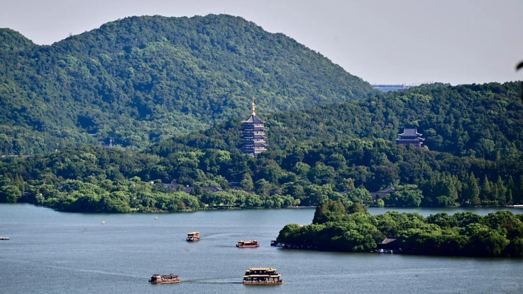 West Lake and Leifeng Pagoda, Hangzhou – Scenic view of boats on West Lake with Leifeng Pagoda nestled among lush green hills in Hangzhou, China - What is Hangzhou best known for? 2026 - The China Journey - Lantern Festival, the End of Chinese New Year 2026 - The China Journey West Lake and Leifeng Pagoda, Hangzhou – Scenic view of boats on West Lake with Leifeng Pagoda nestled among lush green hills in Hangzhou, China - What is Hangzhou best known for? 2026 - The China Journey - Lantern Festival, the End of Chinese New Year 2026 - The China Journey