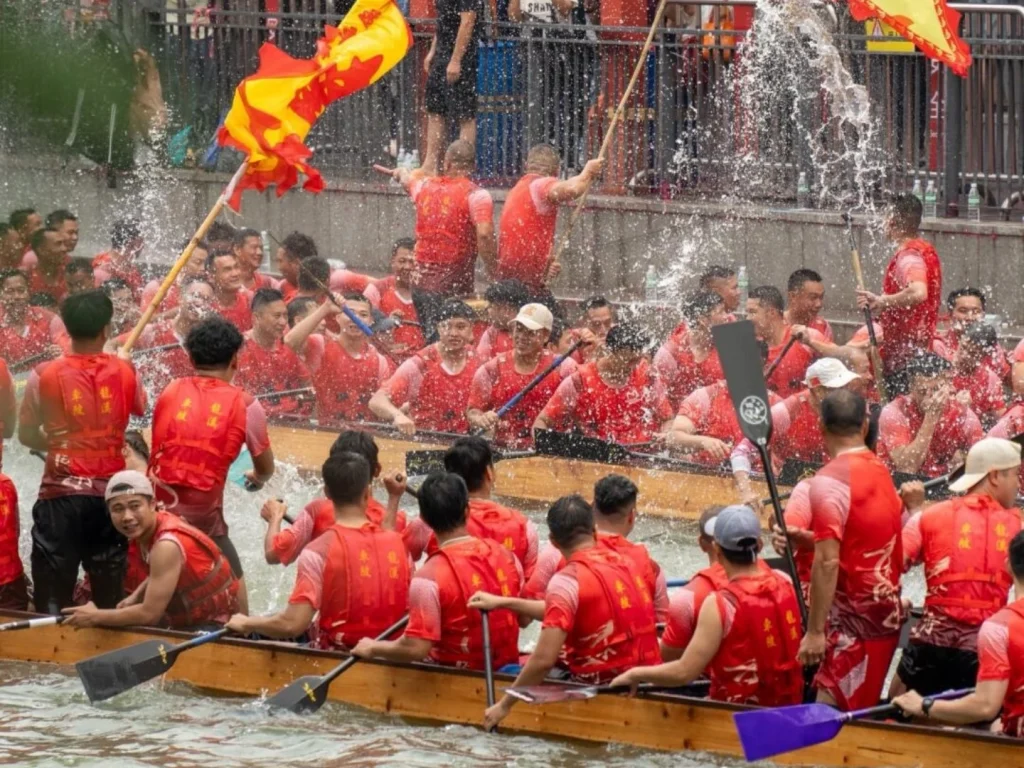 Dragon boat race in Guangzhou – festive crowds and rowers in red vests celebrate Duanwu Festival with splashes and team spirit. - Chinese Holidays and Festivals in 2026: Dates, Traditions & Travel Guide - The China Journey Dragon boat race in Guangzhou – festive crowds and rowers in red vests celebrate Duanwu Festival with splashes and team spirit. - Chinese Holidays and Festivals in 2026: Dates, Traditions & Travel Guide - The China Journey