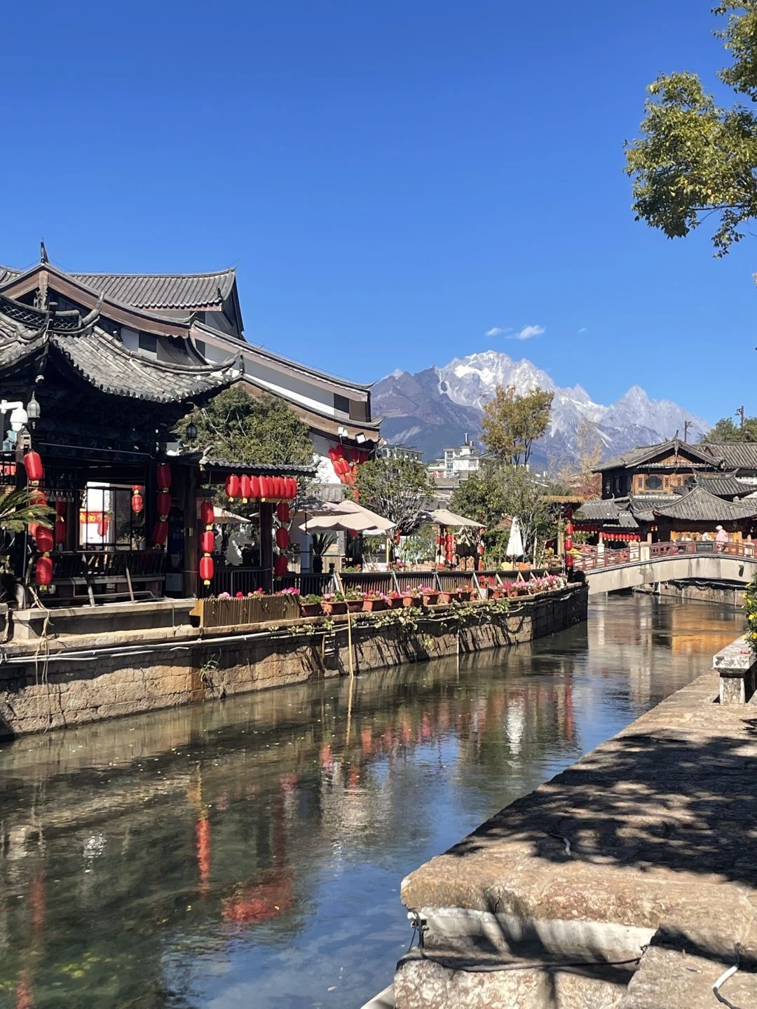 Lijiang Old Town and Snow Mountain Traditional architecture of Lijiang Old Town with red lanterns set against the backdrop of snow capped mountains - Where to Stay in Lijiang: Best Areas & Hotels 2026 - The China Journey Lijiang Old Town and Snow Mountain Traditional architecture of Lijiang Old Town with red lanterns set against the backdrop of snow capped mountains - Where to Stay in Lijiang: Best Areas & Hotels 2026 - The China Journey