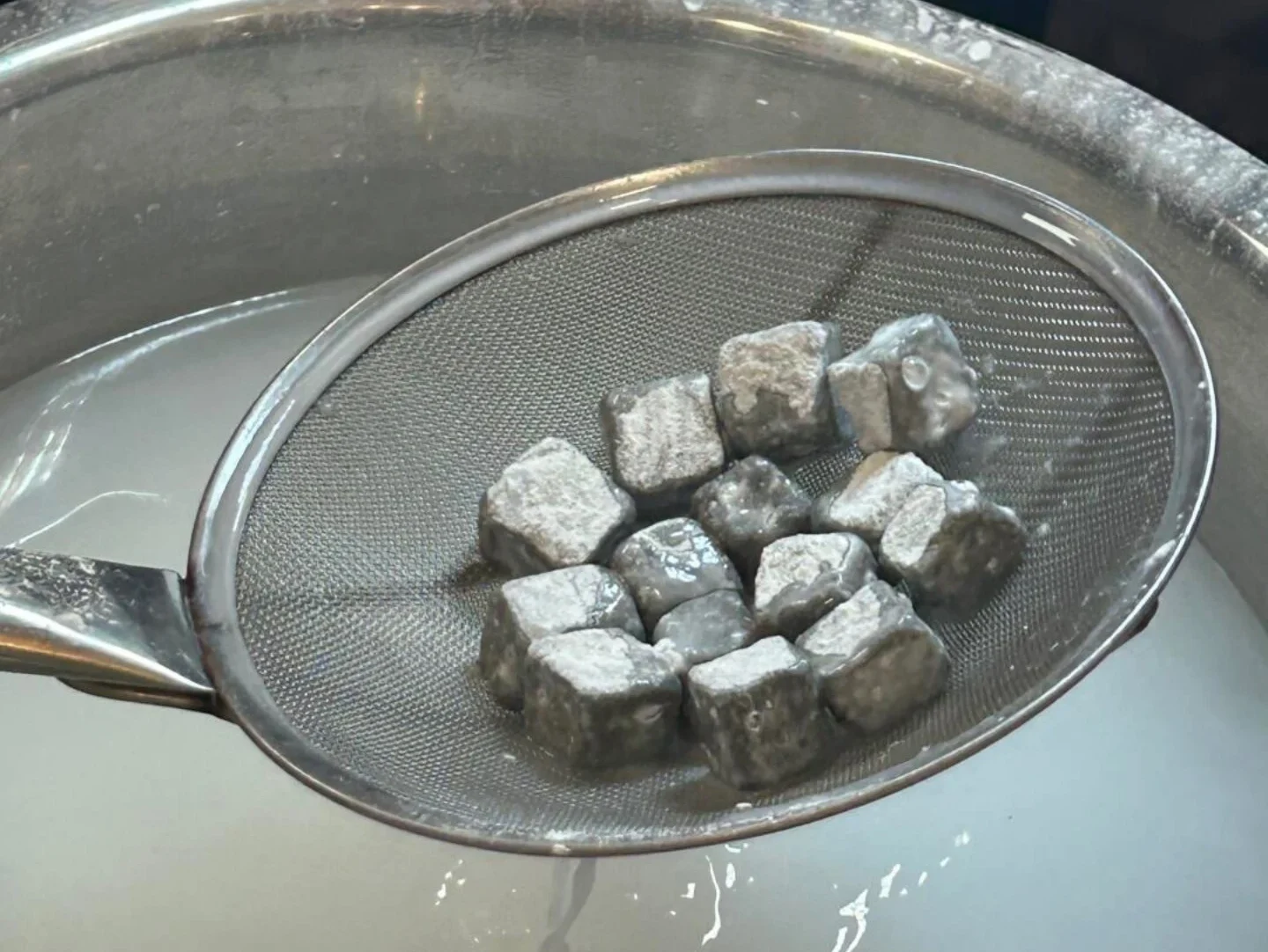 Sticky cube fillings soaked before coating in rice flour.