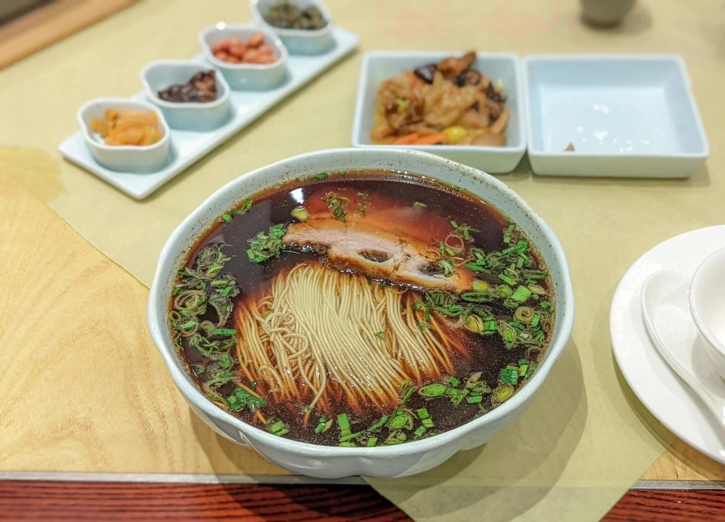 Suzhou style Aozao noodles in rich dark broth topped with pork slices and scallions, Jiangsu breakfast - What to Eat in Suzhou: Local Food Guide 2026 - The China Journey Suzhou style Aozao noodles in rich dark broth topped with pork slices and scallions, Jiangsu breakfast - What to Eat in Suzhou: Local Food Guide 2026 - The China Journey