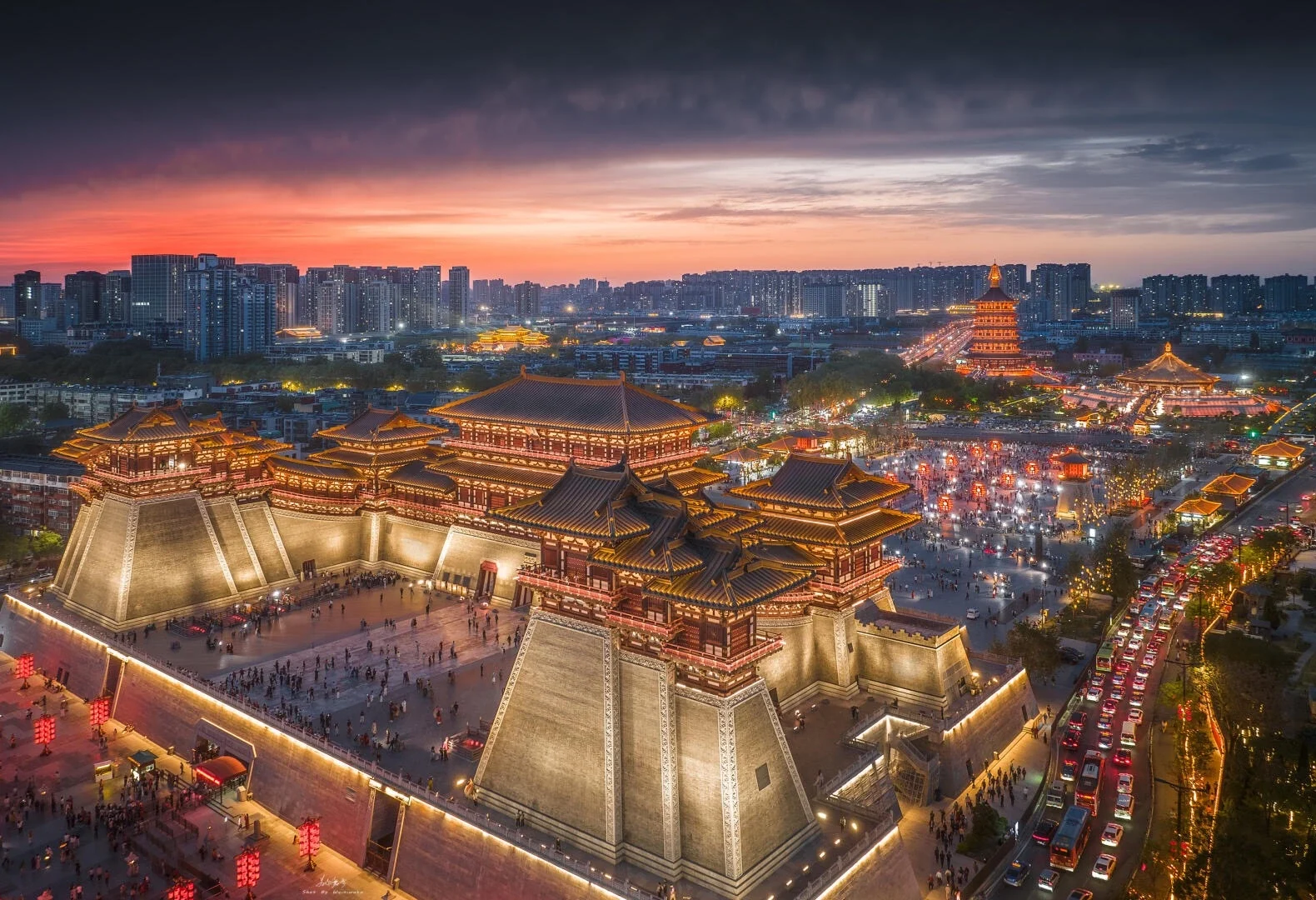Aerial view of Luoyang Yingtian Gate at sunset with golden lights and city skyline - Where to Stay in Luoyang: Best Areas & Hotels 2026 - The China Journey Aerial view of Luoyang Yingtian Gate at sunset with golden lights and city skyline - Where to Stay in Luoyang: Best Areas & Hotels 2026 - The China Journey