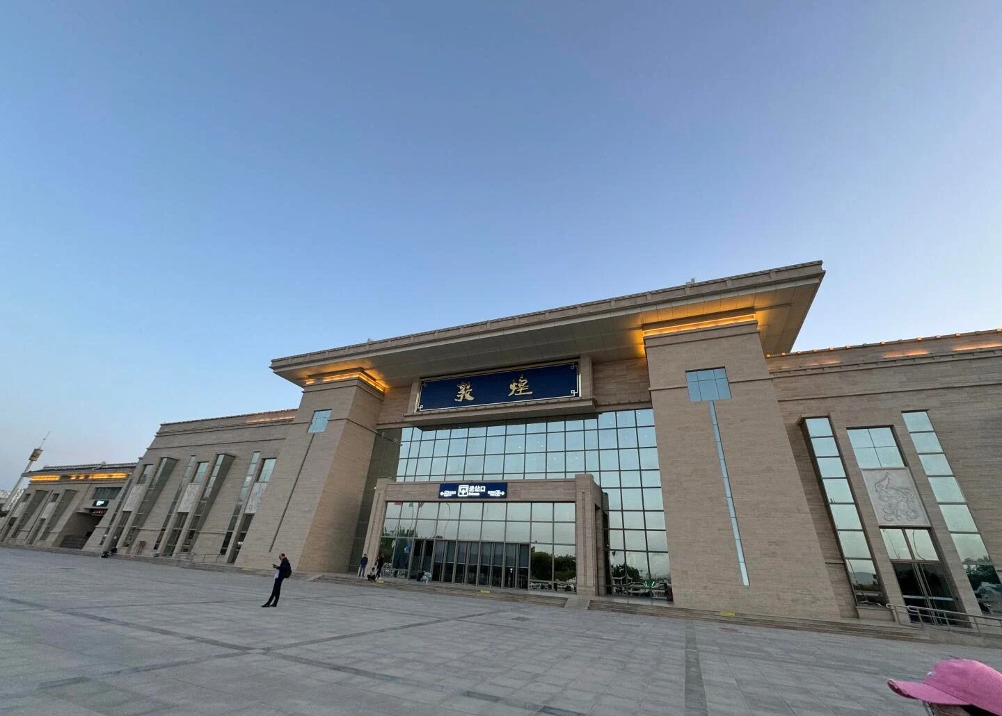 Moderne facade af Dunhuang Station ved solnedgang - Overnatning i Dunhuang: Bedste områder og hoteller 2026 - The China Journey Moderne facade af Dunhuang Station ved solnedgang - Overnatning i Dunhuang: Bedste områder og hoteller 2026 - The China Journey
