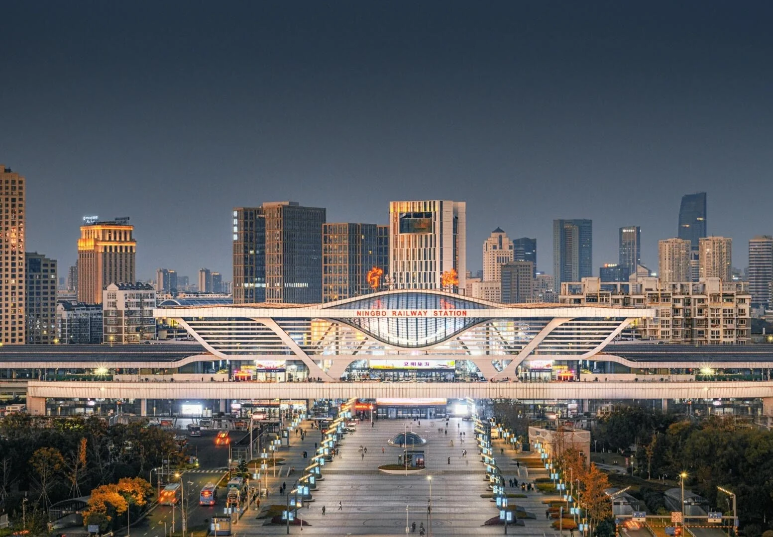 Night view of Ningbo Railway Station with modern facade and city skyline backdrop - Where to Stay in Ningbo: Best Areas & Hotels 2026 - The China Journey Night view of Ningbo Railway Station with modern facade and city skyline backdrop - Where to Stay in Ningbo: Best Areas & Hotels 2026 - The China Journey