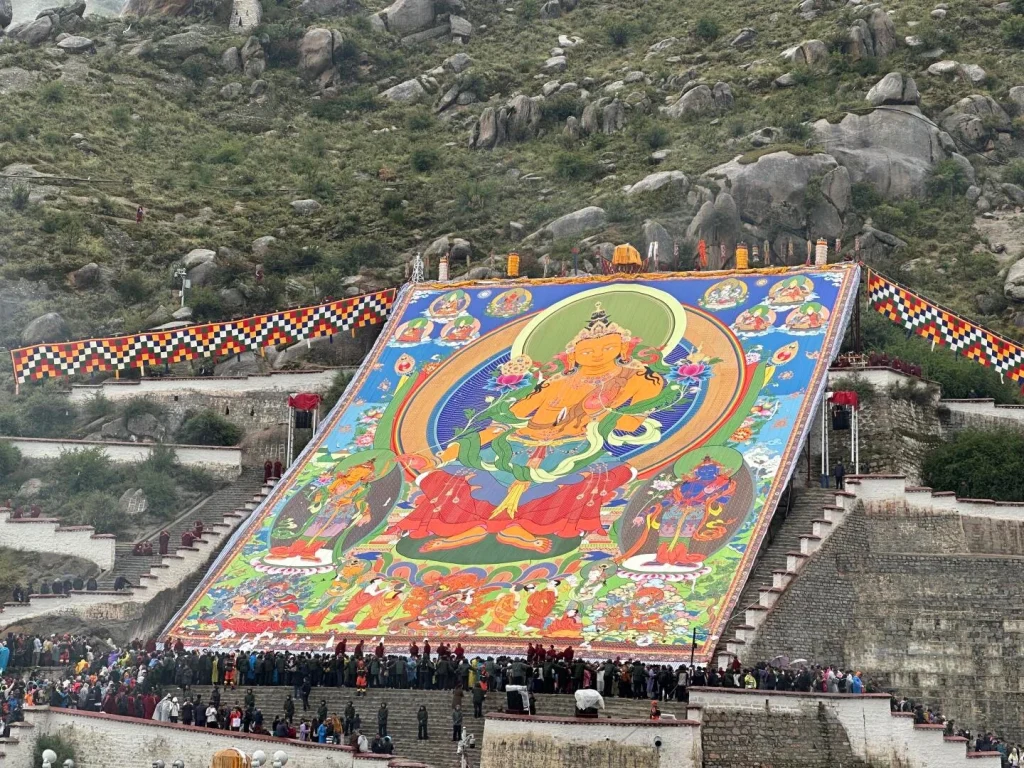 Shoton Festival Thangka Display – Giant colorful Buddha thangka unveiled at Drepung Monastery, with crowds of pilgrims gathered at the mountainside - Chinese Holidays and Festivals in 2026: Dates, Traditions & Travel Guide - The China Journey Shoton Festival Thangka Display – Giant colorful Buddha thangka unveiled at Drepung Monastery, with crowds of pilgrims gathered at the mountainside - Chinese Holidays and Festivals in 2026: Dates, Traditions & Travel Guide - The China Journey