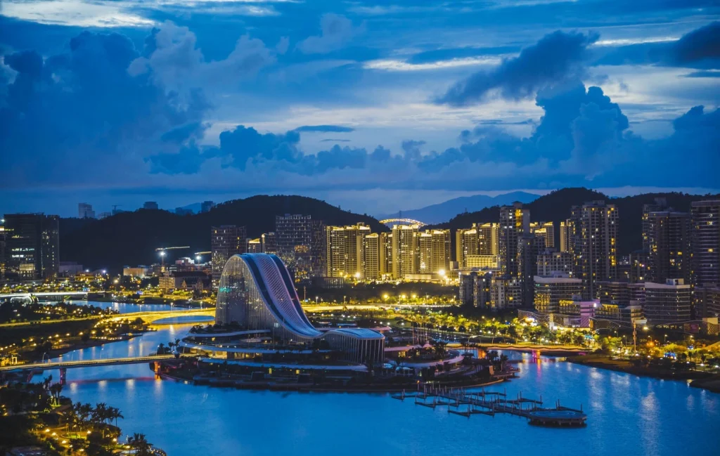 Hengqin Island, Zhuhai – Night view of Hengqin Island skyline with illuminated modern buildings reflected on the river, showcasing Zhuhai’s coastal urban landscape at dusk. - Where to Stay in Zhuhai: Best Areas & Hotels 2026 - The China Journey - Bed Feng Shui Tips from Chinese Masters 2026 - The China Journey Hengqin Island, Zhuhai – Night view of Hengqin Island skyline with illuminated modern buildings reflected on the river, showcasing Zhuhai’s coastal urban landscape at dusk. - Where to Stay in Zhuhai: Best Areas & Hotels 2026 - The China Journey - Bed Feng Shui Tips from Chinese Masters 2026 - The China Journey