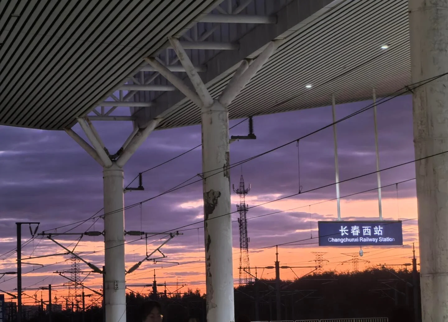 Changchun West Railway Station – High speed railway station platform at sunset, with modern steel structures and signage highlighting Changchun’s role as a major transport hub - Where to Stay in Changchun: Best Areas & Hotels 2026 - The China Journey Changchun West Railway Station – High speed railway station platform at sunset, with modern steel structures and signage highlighting Changchun’s role as a major transport hub - Where to Stay in Changchun: Best Areas & Hotels 2026 - The China Journey
