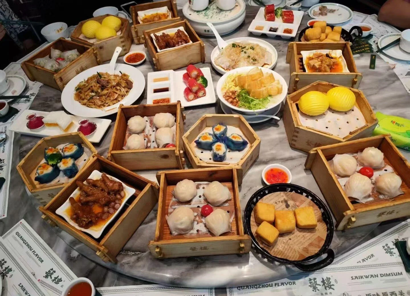 Full Cantonese Dim Sum Feast – Wide selection of Cantonese dim sum dishes arranged on a large table, featuring handmade dumplings, buns, desserts, and tea for a complete yum cha experience - What to Eat in Guangzhou: Local Food Guide 2026 - The China Journey Full Cantonese Dim Sum Feast – Wide selection of Cantonese dim sum dishes arranged on a large table, featuring handmade dumplings, buns, desserts, and tea for a complete yum cha experience - What to Eat in Guangzhou: Local Food Guide 2026 - The China Journey