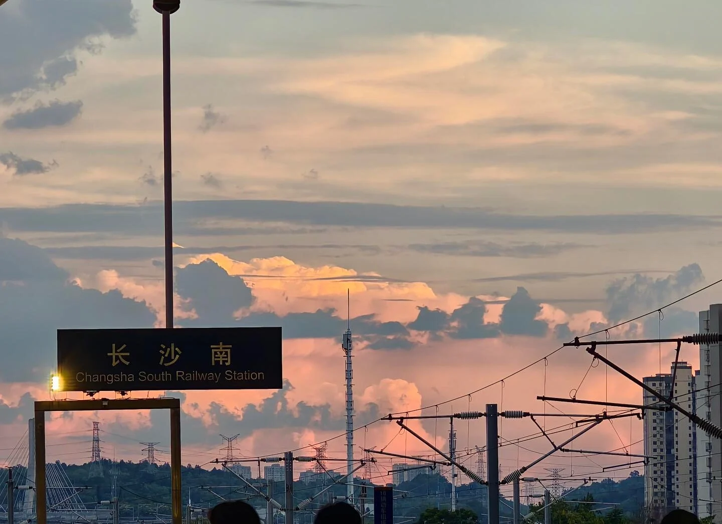 Changsha South Railway Station Sunset Urban railway infrastructure silhouetted against warm evening sky and glowing clouds - Where to Stay in Changsha: Best Areas & Hotels 2026 - The China Journey Changsha South Railway Station Sunset Urban railway infrastructure silhouetted against warm evening sky and glowing clouds - Where to Stay in Changsha: Best Areas & Hotels 2026 - The China Journey