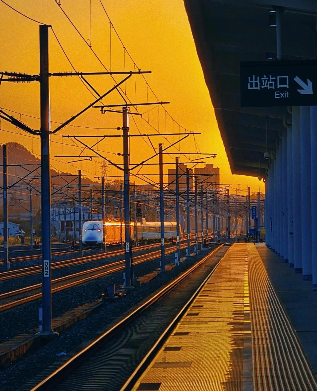 Jingdezhen North Railway Station Sunset High speed train arriving at station platform with golden sunset light and urban skyline - Jiangxi Travel Guide: Routes, Tips & Itineraries 2026 - The China Journey Jingdezhen North Railway Station Sunset High speed train arriving at station platform with golden sunset light and urban skyline - Jiangxi Travel Guide: Routes, Tips & Itineraries 2026 - The China Journey