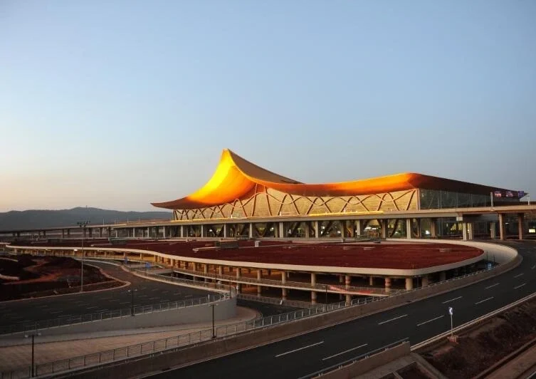 Buitenkant van de internationale luchthaven Kunming Changshui met moderne terminalarchitectuur, golvend dak en toegangswegen - Reisgids voor Kunming: routes, tips en de beste activiteiten 2026 - The China Journey Buitenkant van de internationale luchthaven Kunming Changshui met moderne terminalarchitectuur, golvend dak en toegangswegen - Reisgids voor Kunming: routes, tips en de beste activiteiten 2026 - The China Journey