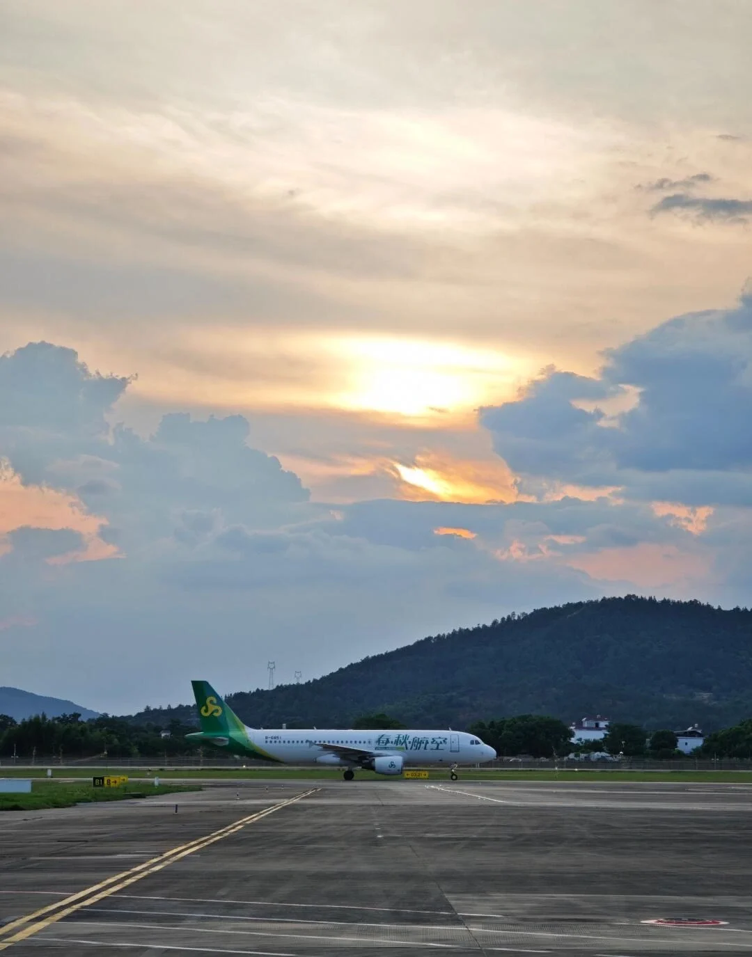 Nanchang Changbei Airport Runway Sunset Commercial airplane taxiing on runway with dramatic sunset clouds and mountain backdrop - Jiangxi Travel Guide: Routes, Tips & Itineraries 2026 - The China Journey Nanchang Changbei Airport Runway Sunset Commercial airplane taxiing on runway with dramatic sunset clouds and mountain backdrop - Jiangxi Travel Guide: Routes, Tips & Itineraries 2026 - The China Journey