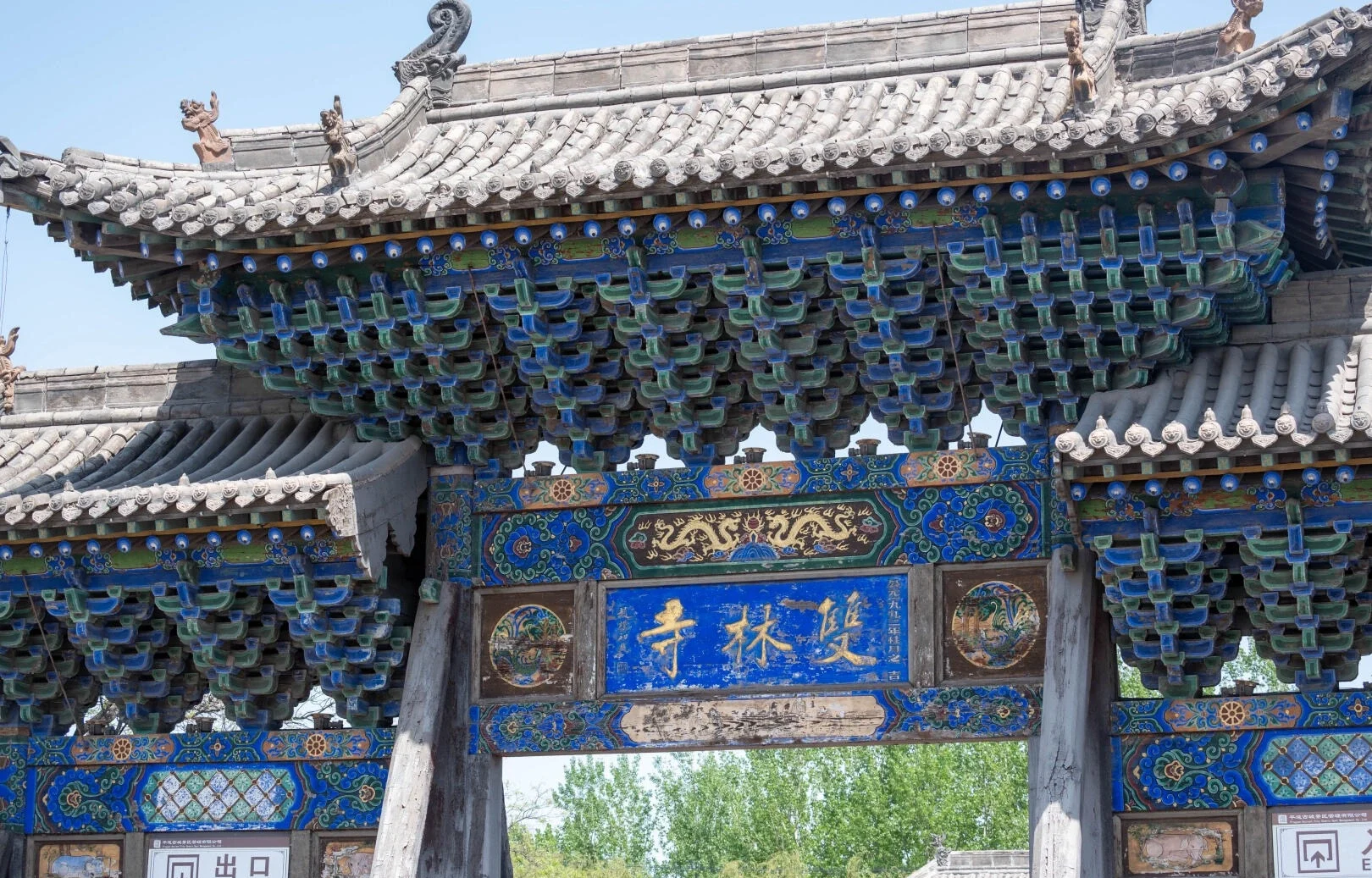 Porta dipinta del tempio di Shuanglin: un intricato arco in legno con intagli colorati che mostrano l'antica architettura dei templi buddisti nello Shanxi - Guida di viaggio dello Shanxi: itinerari, consigli e luoghi da non perdere 2026 - The China Journey Porta dipinta del tempio di Shuanglin: un intricato arco in legno con intagli colorati che mostrano l'antica architettura dei templi buddisti nello Shanxi - Guida di viaggio dello Shanxi: itinerari, consigli e luoghi da non perdere 2026 - The China Journey