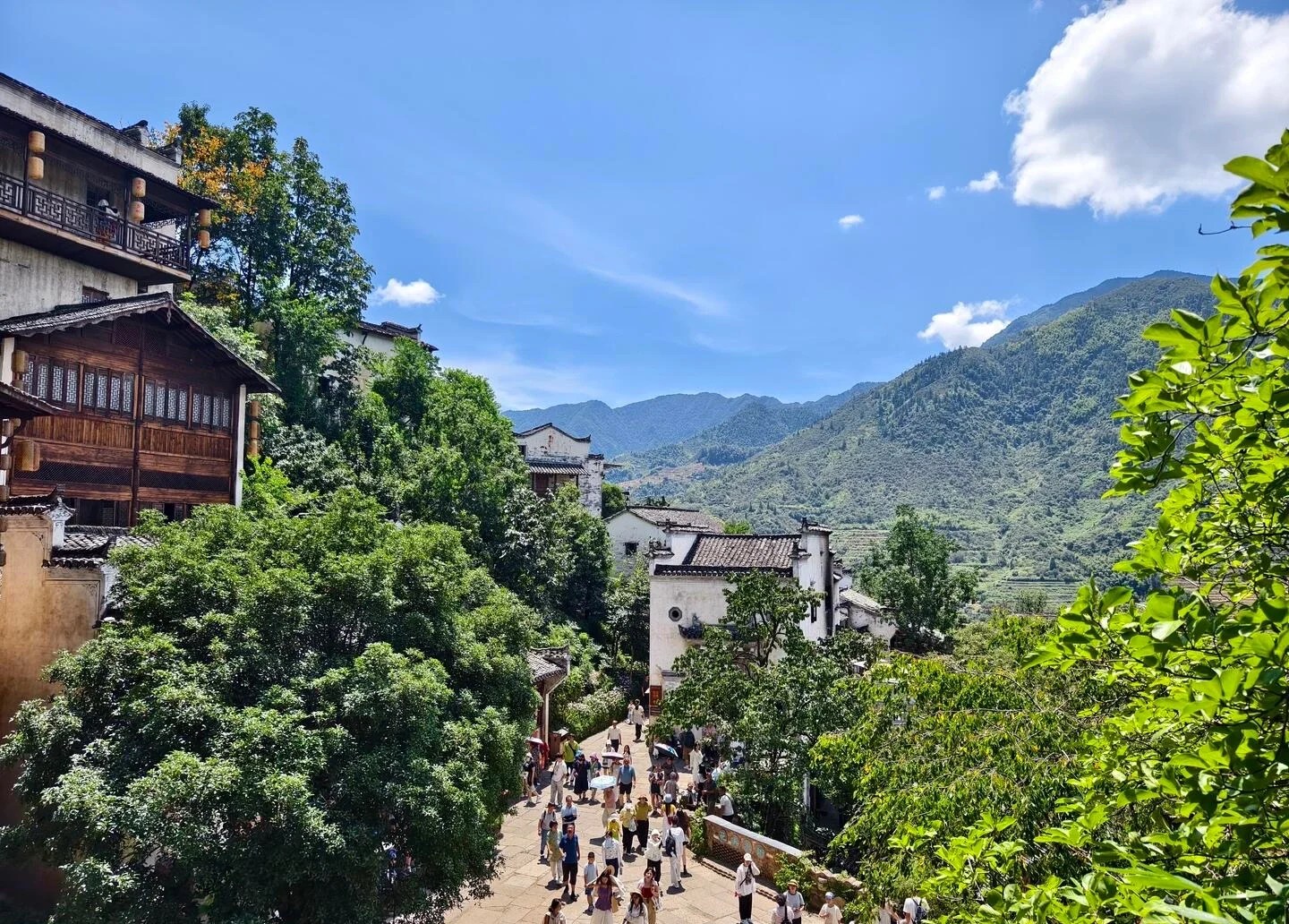 Wuyuan Scenic Village Street View Tourists walking through traditional houses with lush greenery and mountain backdrop Jiangxi - Jiangxi Travel Guide: Routes, Tips & Itineraries 2026 - The China Journey Wuyuan Scenic Village Street View Tourists walking through traditional houses with lush greenery and mountain backdrop Jiangxi - Jiangxi Travel Guide: Routes, Tips & Itineraries 2026 - The China Journey