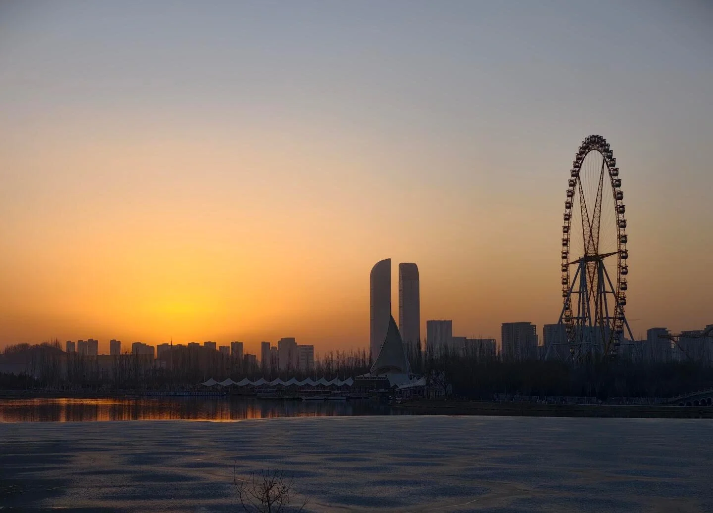 Yuehai Lake Sunrise Yinchuan Skyline Golden dawn reflecting on frozen lake with Ferris wheel and modern city buildings - Ningxia Travel Guide: Routes, Desert & Culture 2026 - The China Journey Yuehai Lake Sunrise Yinchuan Skyline Golden dawn reflecting on frozen lake with Ferris wheel and modern city buildings - Ningxia Travel Guide: Routes, Desert & Culture 2026 - The China Journey