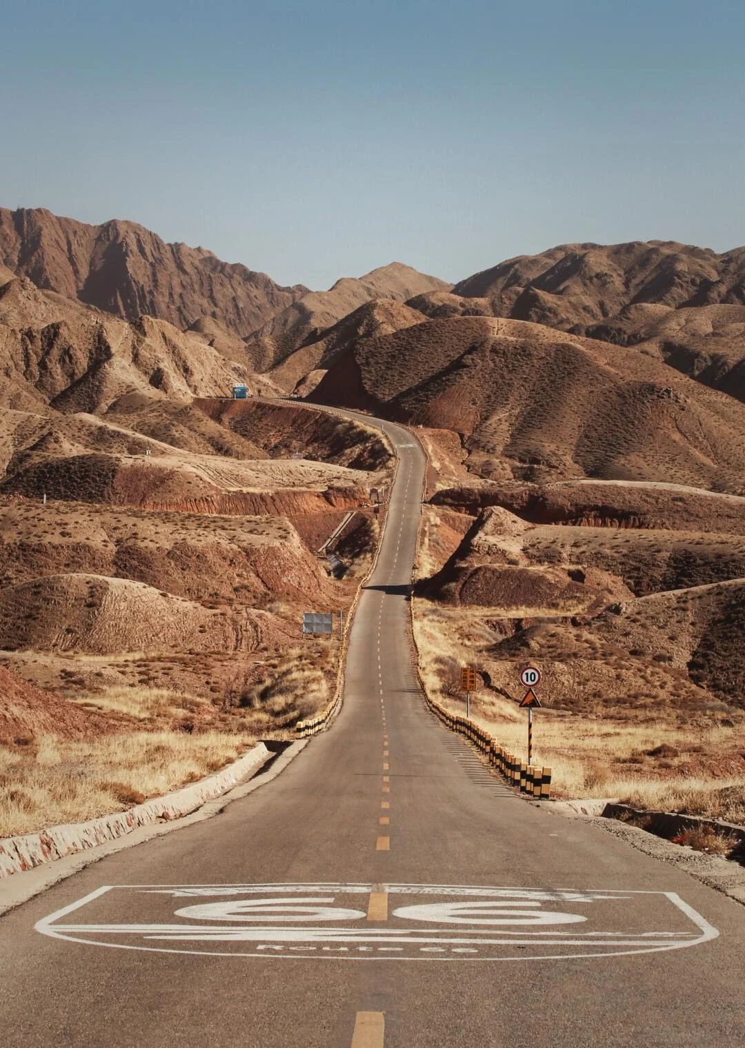 Zhongwei Route 66 Desert Highway Scenic road stretching through arid mountains with clear sky and travel adventure vibe - Ningxia Travel Guide: Routes, Desert & Culture 2026 - The China Journey Zhongwei Route 66 Desert Highway Scenic road stretching through arid mountains with clear sky and travel adventure vibe - Ningxia Travel Guide: Routes, Desert & Culture 2026 - The China Journey