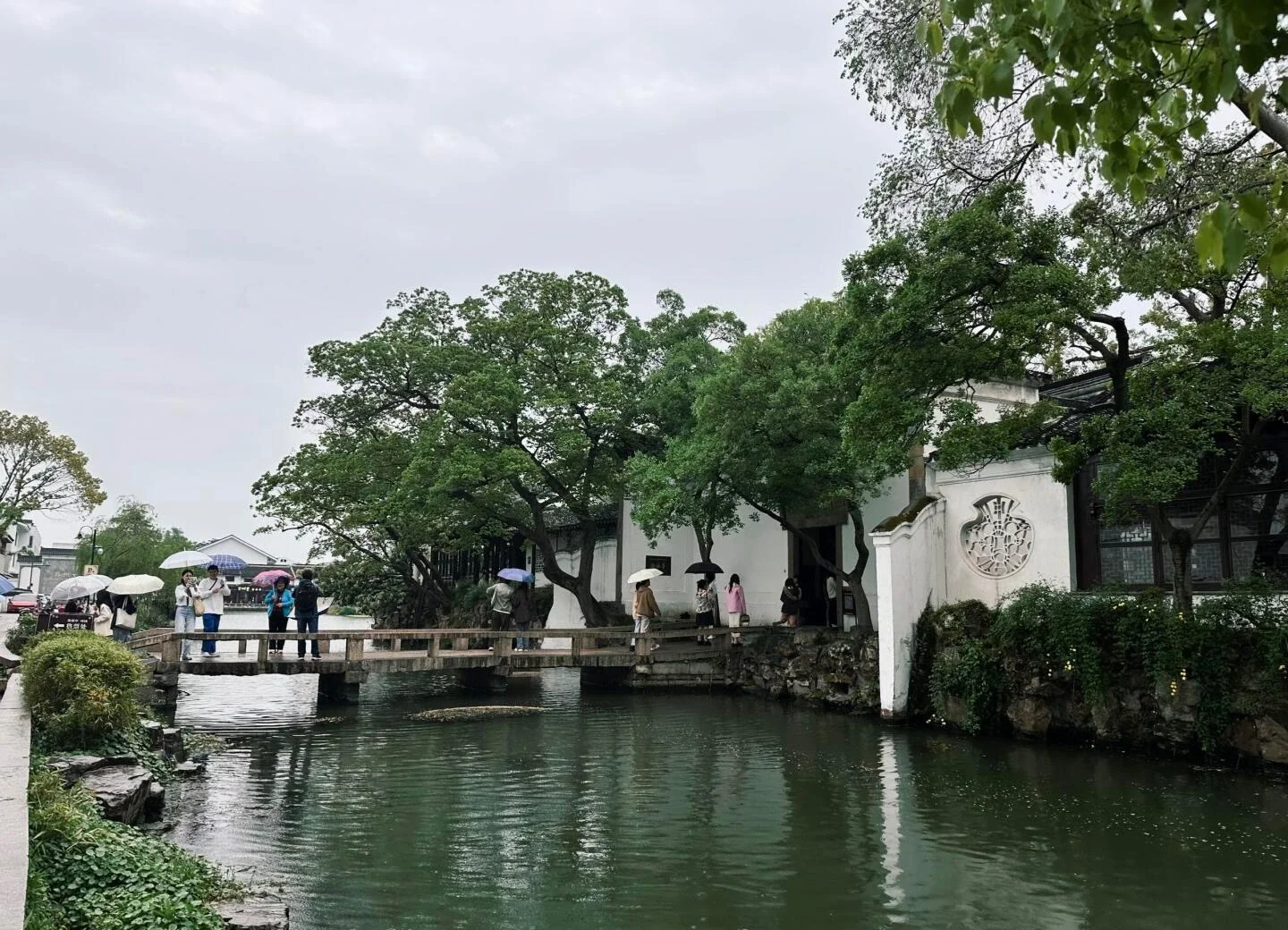 Canglang Pavilion Suzhou Garden Classical Chinese garden with stone bridge water reflections and visitors exploring serene landscape - Where to Stay in Suzhou: Best Areas & Hotels 2026 - The China Journey Canglang Pavilion Suzhou Garden Classical Chinese garden with stone bridge water reflections and visitors exploring serene landscape - Where to Stay in Suzhou: Best Areas & Hotels 2026 - The China Journey