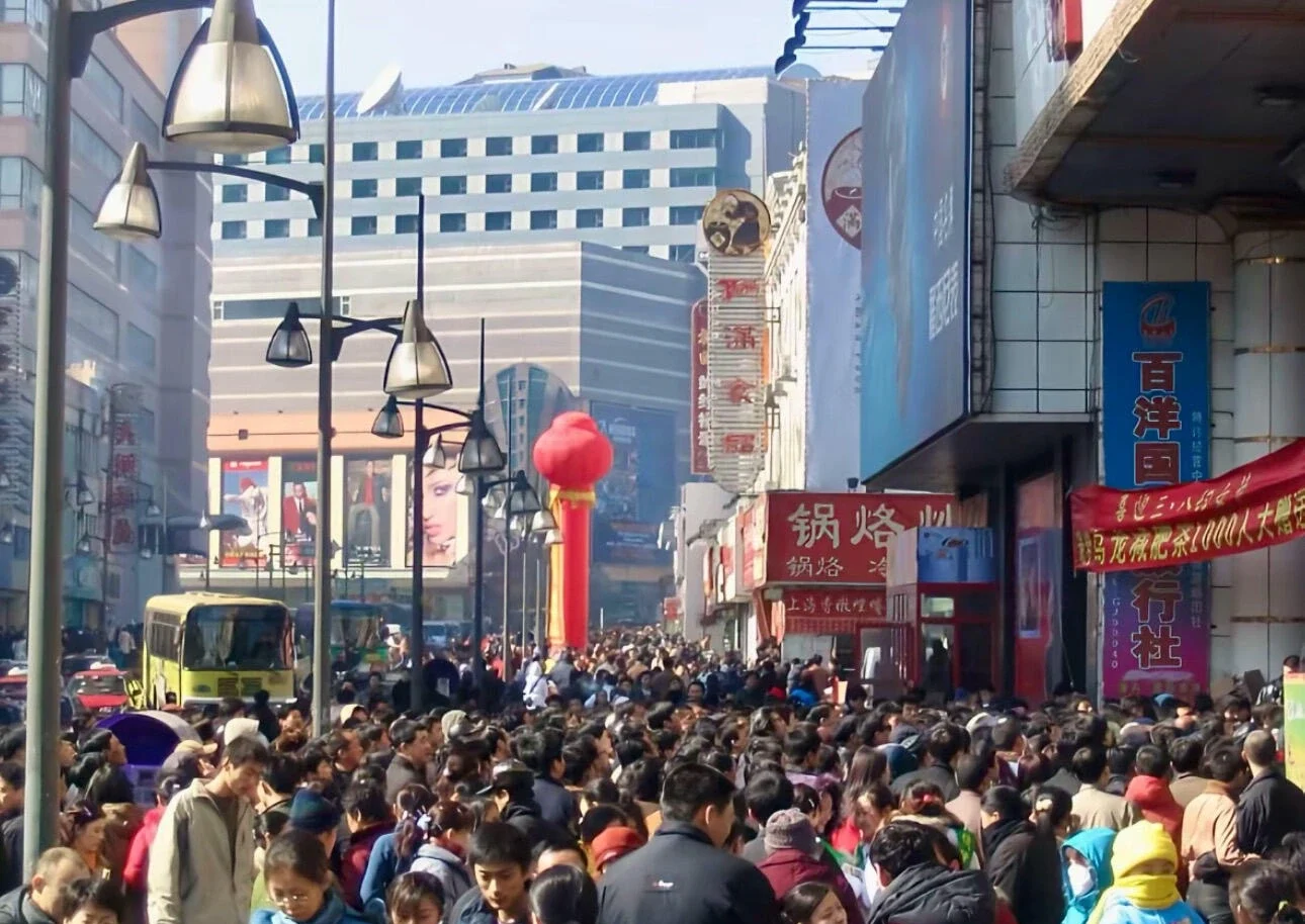 Changchun Chongqing Road Commercial Street Crowd Busy pedestrian shopping street packed with locals storefront signs and urban retail atmosphere in daytime - Where to Stay in Changchun: Best Areas & Hotels 2026 - The China Journey Changchun Chongqing Road Commercial Street Crowd Busy pedestrian shopping street packed with locals storefront signs and urban retail atmosphere in daytime - Where to Stay in Changchun: Best Areas & Hotels 2026 - The China Journey