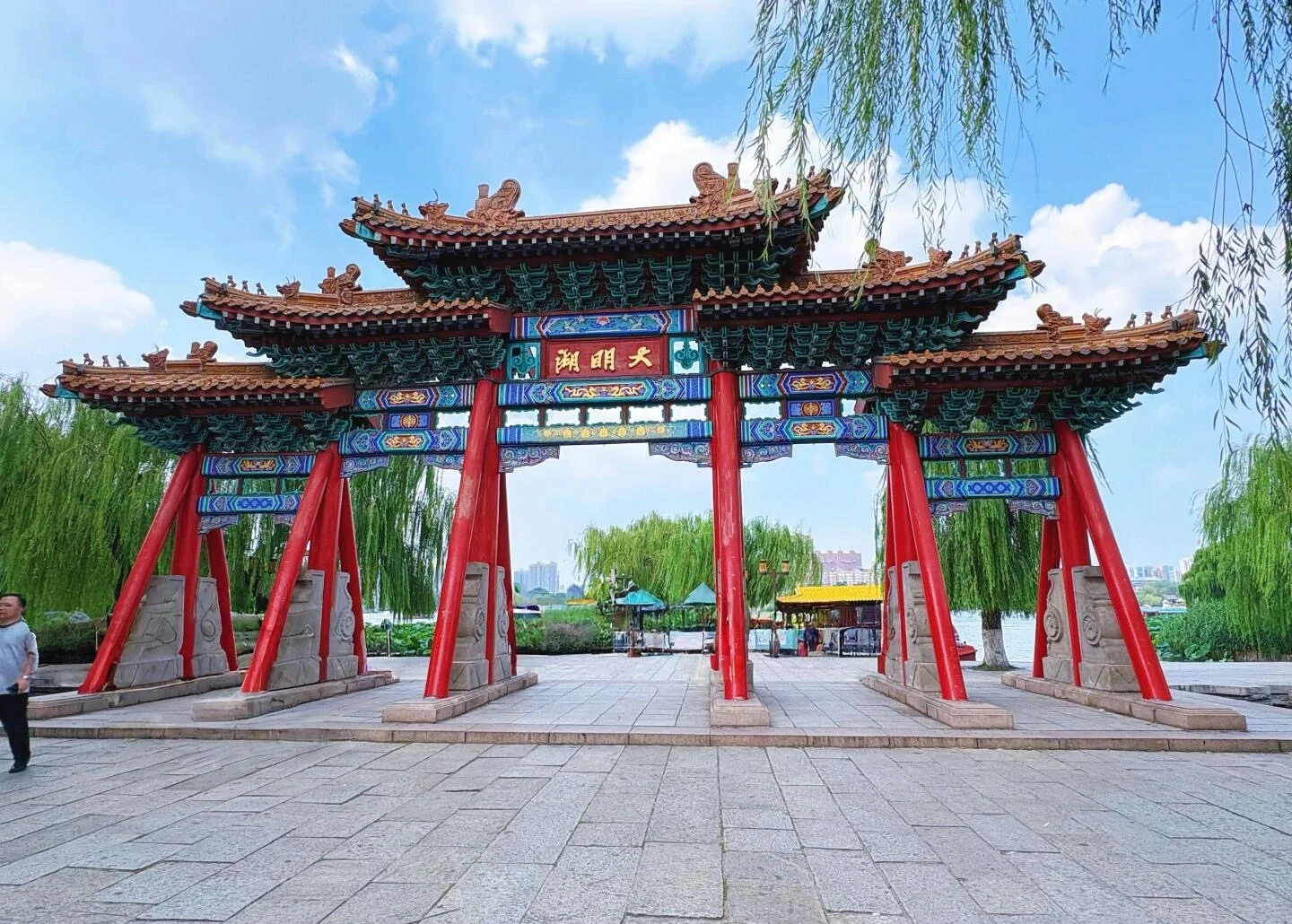 Den udsmykkede portindgang ved Daming Lake, traditionel kinesisk port med farverige udskæringer ved piletræer og sølandskab i Jinan - Jinan rejseguide: Bedste rejseplan og tips 2026 - The China Journey Den udsmykkede portindgang ved Daming Lake, traditionel kinesisk port med farverige udskæringer ved piletræer og sølandskab i Jinan - Jinan rejseguide: Bedste rejseplan og tips 2026 - The China Journey