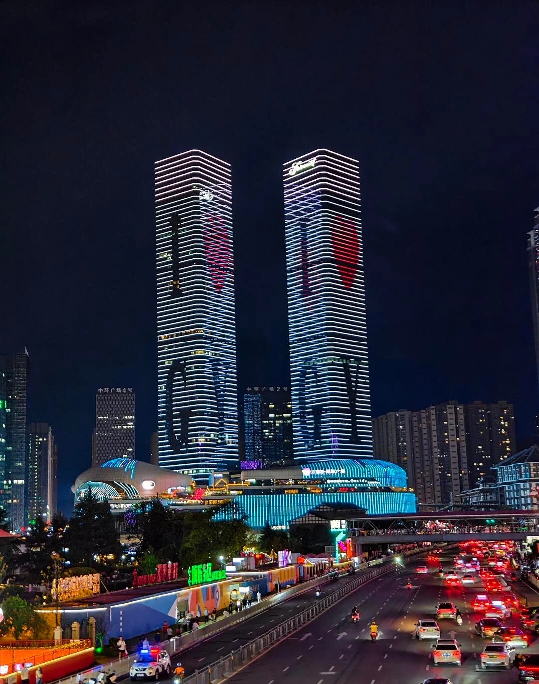 Guiyang Huaguoyuan Commercial District Night View Twin illuminated skyscrapers above busy urban roadway with vibrant city lights and traffic - Where to Stay in Guiyang: Best Areas & Hotels 2026 - The China Journey Guiyang Huaguoyuan Commercial District Night View Twin illuminated skyscrapers above busy urban roadway with vibrant city lights and traffic - Where to Stay in Guiyang: Best Areas & Hotels 2026 - The China Journey