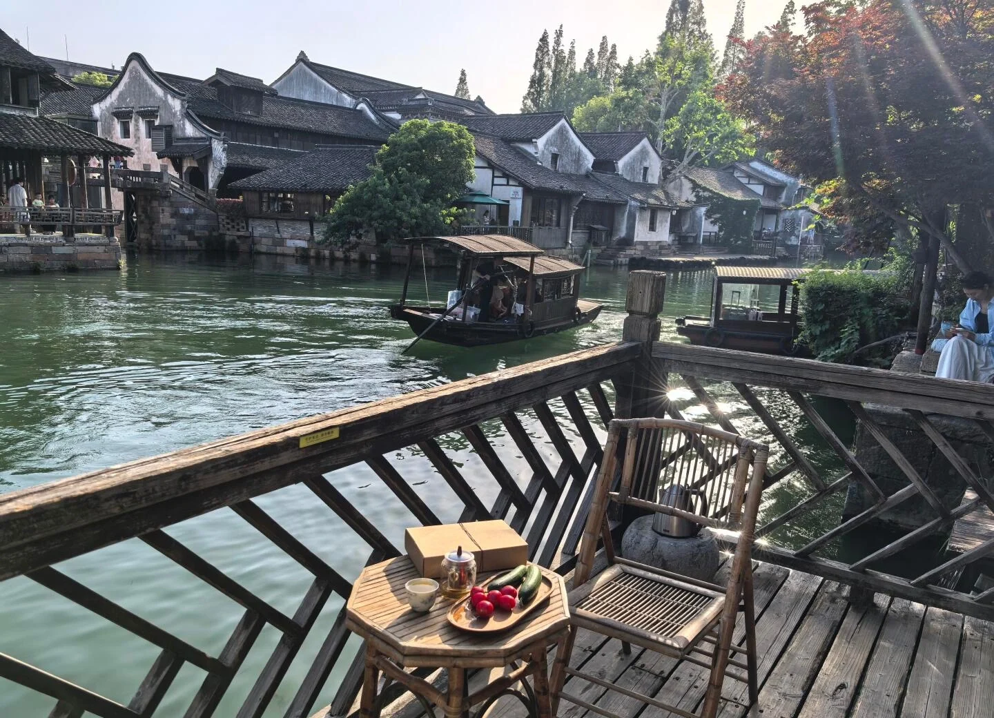Uitzicht vanaf een balkon van een homestay aan de rivier in Wuzhen, met een gezellig houten terras, een theeservies en zicht op het kanaal en traditionele huizen - Reisgids voor Jiaxing: waterstadjes, routes en tips 2026 - The China Journey Uitzicht vanaf een balkon van een homestay aan de rivier in Wuzhen, met een gezellig houten terras, een theeservies en zicht op het kanaal en traditionele huizen - Reisgids voor Jiaxing: waterstadjes, routes en tips 2026 - The China Journey