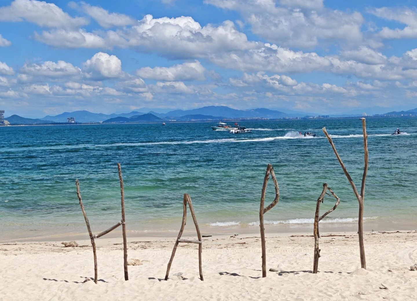 Strand auf der Insel Wuzhizhou in Sanya mit klarem blauem Meer, Schnellbooten und entfernten Bergen – Sanya-Reiseführer: Strände, Buchten & Tipps 2026 – The China Journey Strand auf der Insel Wuzhizhou in Sanya mit klarem blauem Meer, Schnellbooten und entfernten Bergen – Sanya-Reiseführer: Strände, Buchten & Tipps 2026 – The China Journey