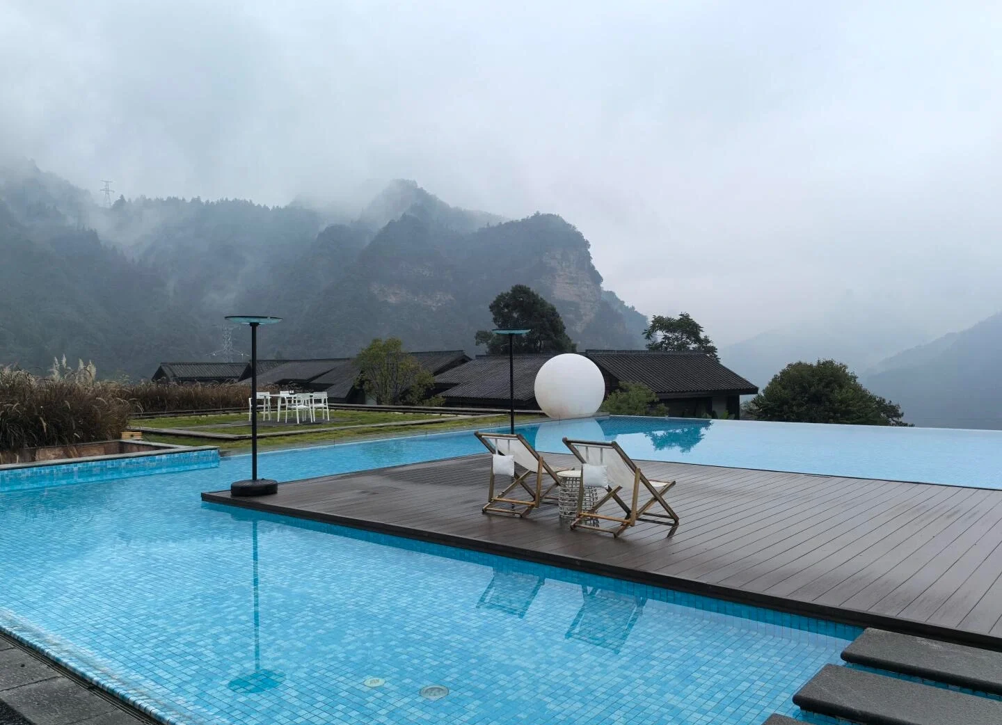 Zhangjiajie Mountain View Resort Pool Infinity pool overlooking misty mountains with peaceful luxury stay experience in nature - Where to Stay in Zhangjiajie: Best Areas & Hotels 2026 - The China Journey Zhangjiajie Mountain View Resort Pool Infinity pool overlooking misty mountains with peaceful luxury stay experience in nature - Where to Stay in Zhangjiajie: Best Areas & Hotels 2026 - The China Journey