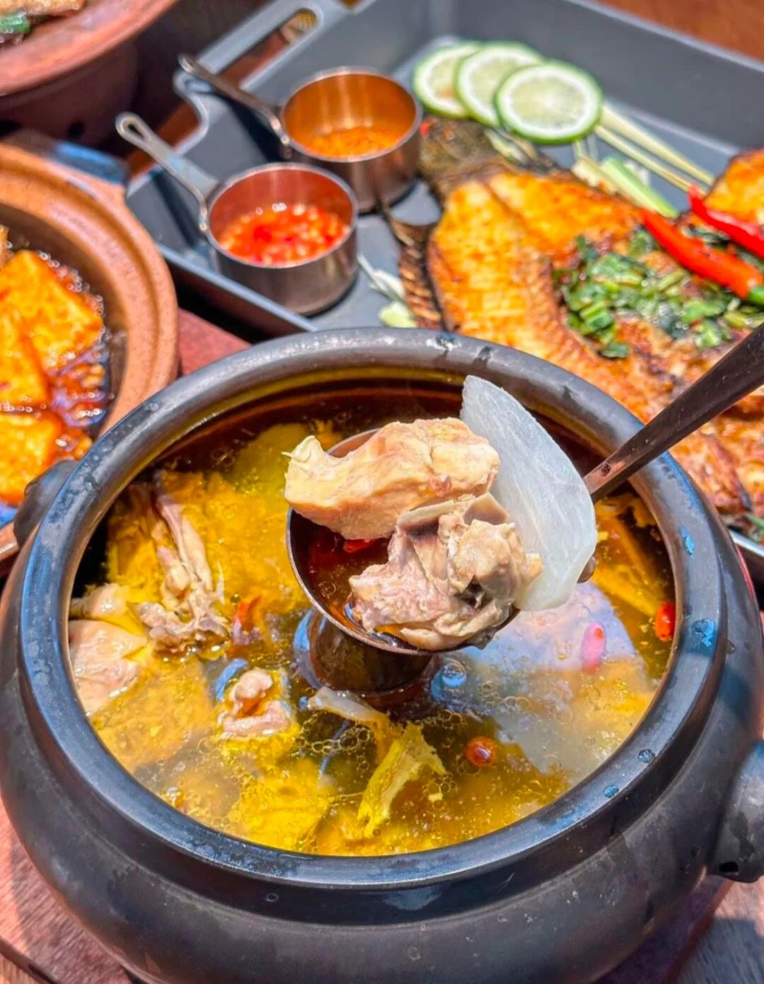 Steam Pot Chicken Yunnan chicken soup served with grilled fish and tofu - What to Eat in Yunnan: Local Food Guide 2026 - The China Journey Steam Pot Chicken Yunnan chicken soup served with grilled fish and tofu - What to Eat in Yunnan: Local Food Guide 2026 - The China Journey